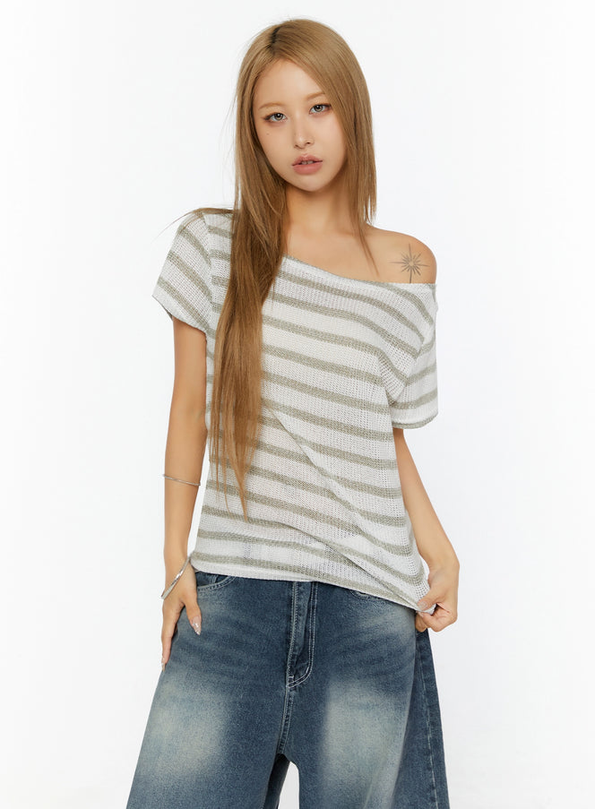Striped Off-Shoulder Top IL524 Dark blue front shot on model showing asymmetric off-shoulder neckline olive stripe open-knit texture paired with wide-leg jeans