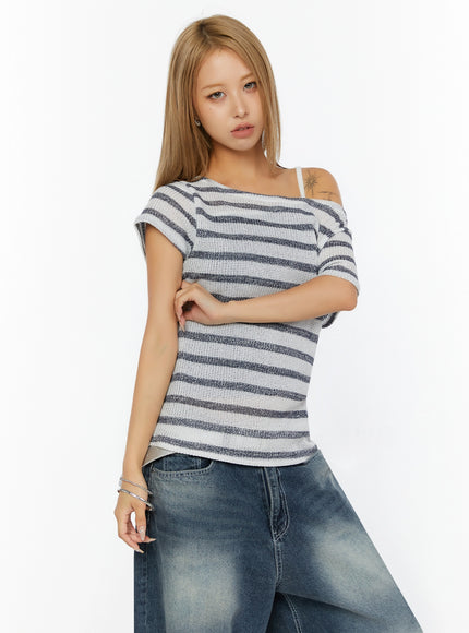Striped Off-Shoulder Top IL524 Dark blue upper-body front shot on model with arms crossed showing fitted open-knit stripe body and asymmetric neckline
