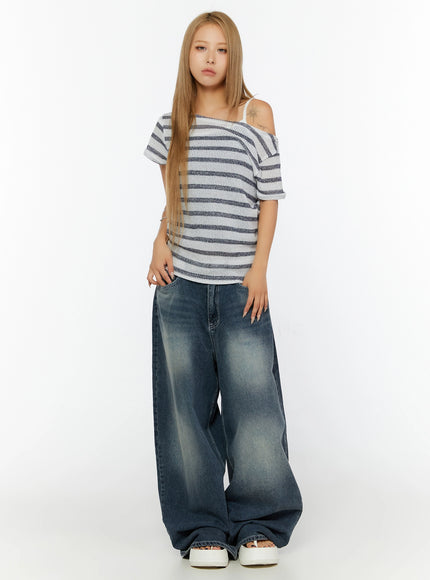 Striped Off-Shoulder Top IL524 Dark blue full-body front shot on model standing straight with hands in pockets off-shoulder neckline styled with wide-leg jeans