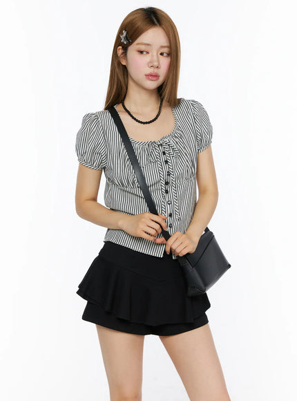 LEWKIN Striped Puff Short Sleeve Blouse CL502 Black three-quarter front shot on model with puff sleeves, tie neckline, button-front, styled with black crossbody bag