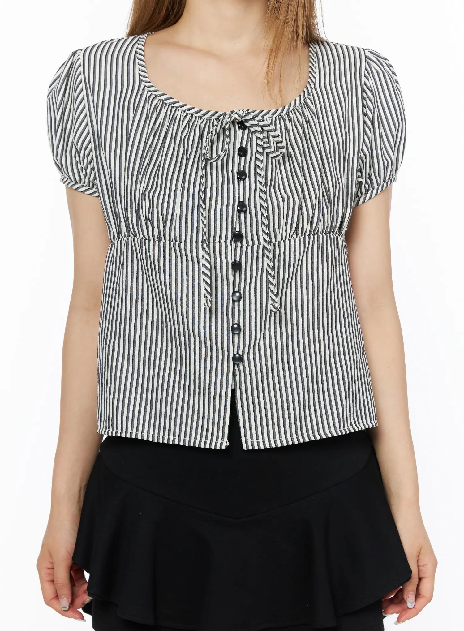 Striped Puff Short Sleeve Blouse CL502 Black close-up front detail shot on model showing scoop neckline, tie detail, black button-front closure, ruched chest, and cinched elastic waist