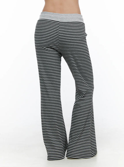 Striped Sweatpants CL513 black-gray back close-up on model showing gray waistband and ribbed black-gray stripe flare leg detail