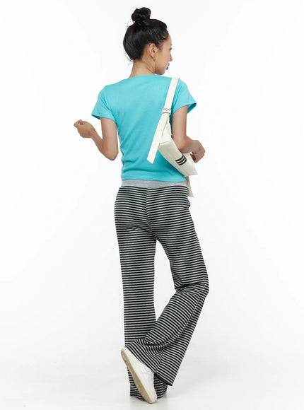 Striped Sweatpants CL513 black-gray back shot on model wearing teal tee and white crossbody bag showing full-length flared silhouette