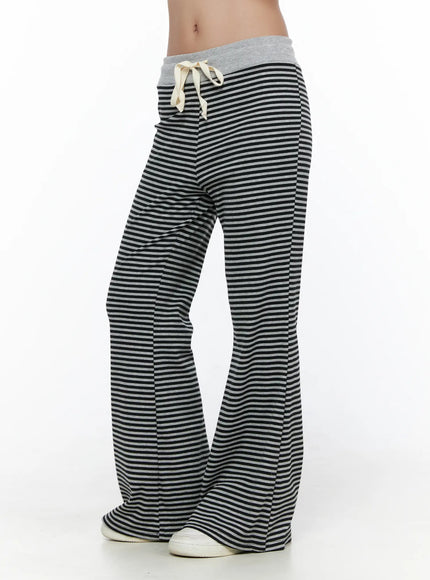 Striped Sweatpants CL513 black-gray side shot on model showing flared leg silhouette and gray contrast waistband with cream drawstring