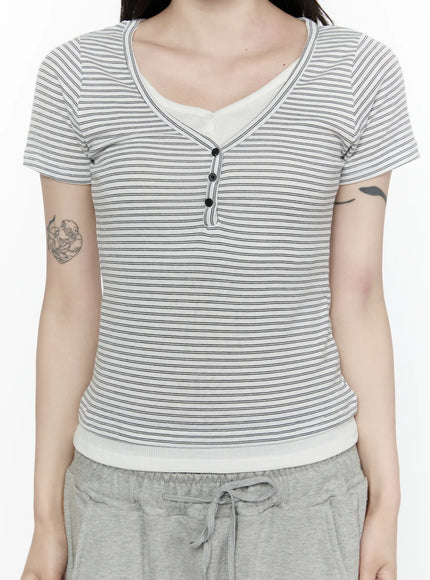Striped T-Shirt IL522 White close-up front crop shot on model, detail view of V-neck henley button placket, horizontal pinstripe pattern and white contrast ribbed hem band