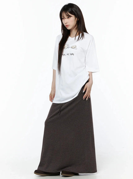 Striped Tie Maxi Skirt IL506 Brown three-quarter front view on model styled with white graphic tee and brown bag, relaxed standing pose