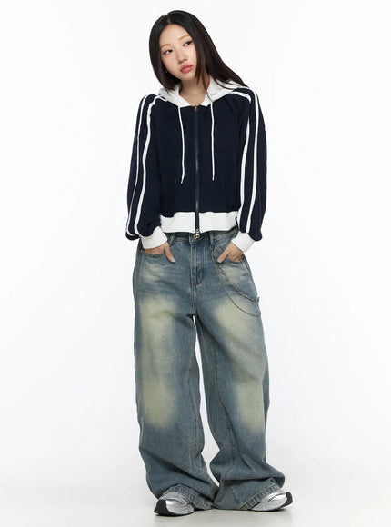 Striped Track Hoodie CL524 Dark blue full-body front shot on model hands in pockets, cropped zip-up with white stripe sleeves and white ribbed cuffs, wide-leg denim styling
