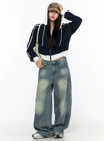 Striped Track Hoodie CL524 Dark blue full-body front shot on model standing with hand on cap, hood up over baseball cap, white stripe sleeves and cropped zip-up silhouette
