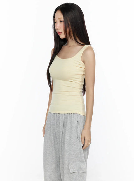 Striped U-Neck Tank Top CL524 Yellow side close-up on model showing fitted ribbed fabric U-neckline and strap detail with gray pants