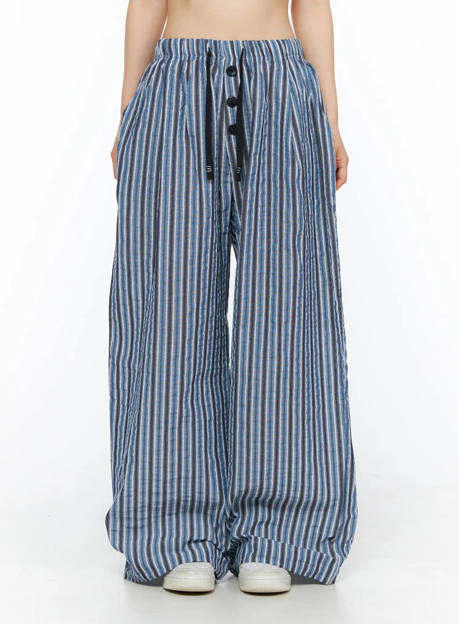 Striped Wide-Leg Trousers CL502 Blue front shot on model showing elastic drawstring waist with three black buttons and wide-leg crinkle stripe silhouette