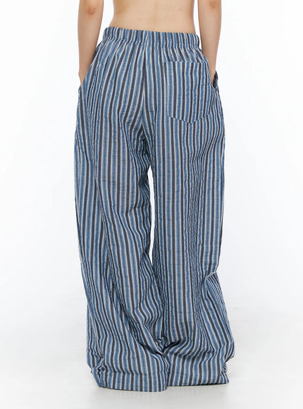 Striped Wide-Leg Trousers CL502 Blue back shot on model showing single back patch pocket and elastic waistband with crinkle stripe fabric