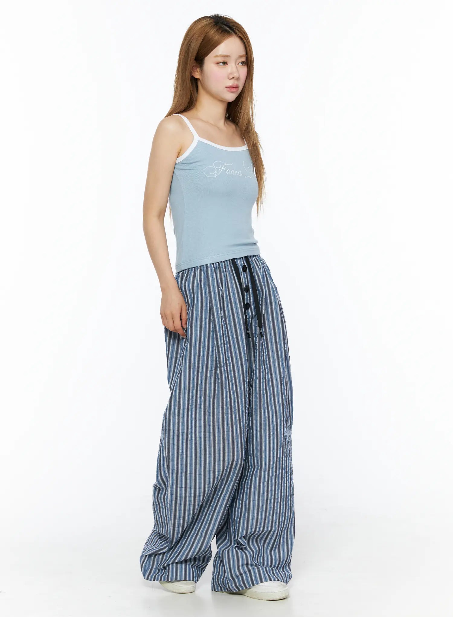 Striped Wide-Leg Trousers CL502 Blue side full-body shot on model styled with blue cami top showing volume of wide-leg crinkle stripe trousers