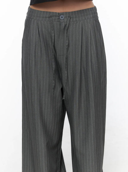 Striped Wide Slacks CL510 gray close-up detail shot on model showing waistband button, front pleats and pinstripe fabric texture