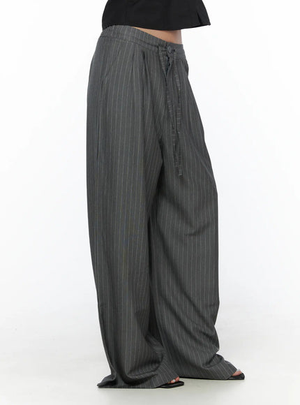 Striped Wide Slacks CL510 gray side shot on model showing voluminous wide-leg drape, drawstring waist detail and floor-grazing length