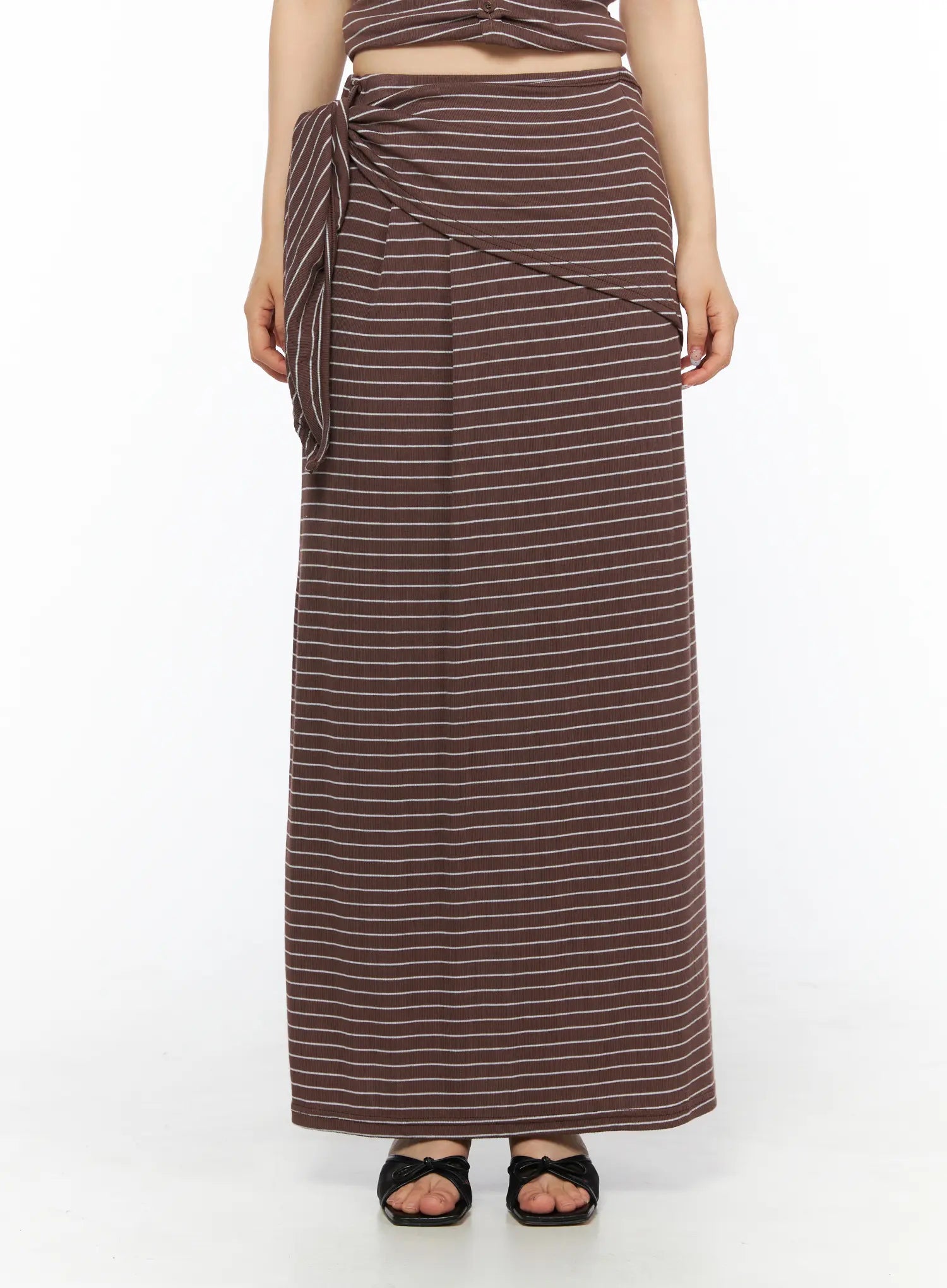 LEWKIN Striped Wrap Maxi Skirt CL502 Brown S/M front view on model cropped at waist showing side-tie knot detail with white stripe ribbed texture and black bow sandals