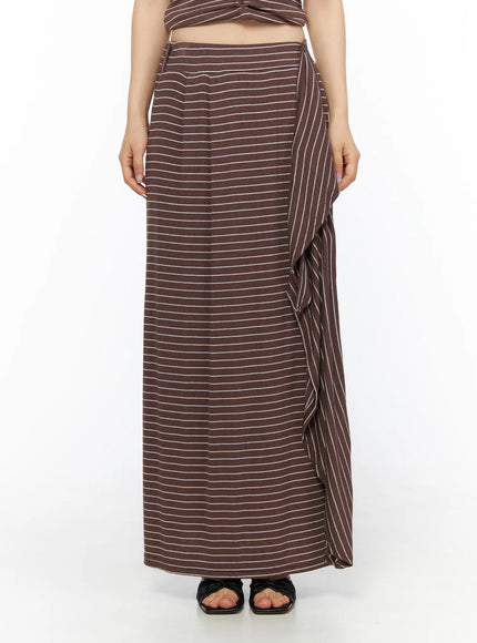 Striped Wrap Maxi Skirt CL502 Brown front close-up view on model showing elasticated waistband side-tie knot center pleat seam and ribbed striped fabric detail