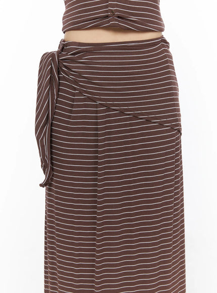 Striped Wrap Maxi Skirt CL502 Brown close-up front detail of side-tie knot waistband wrap drape seam lines and ribbed white stripe fabric texture on model