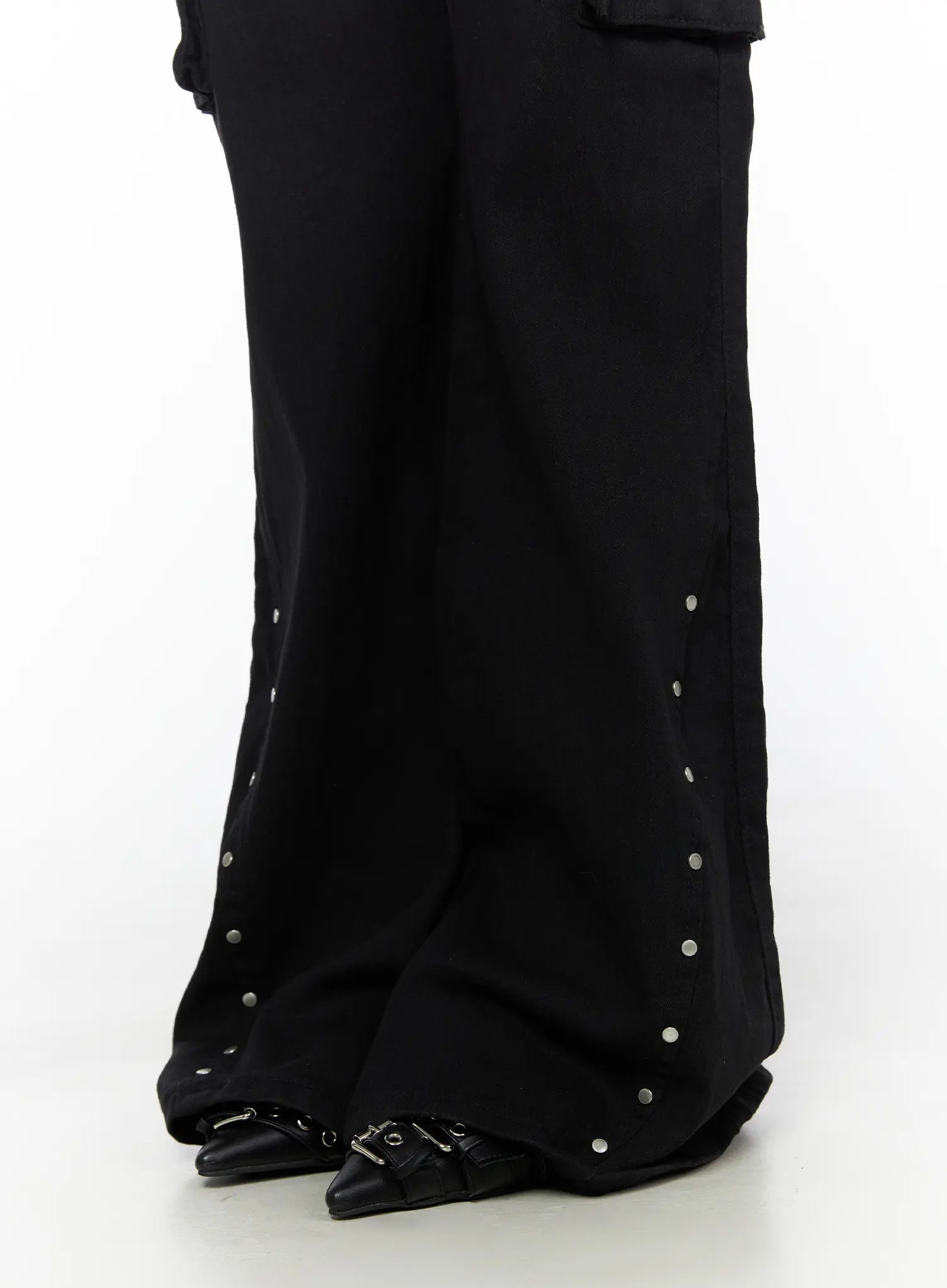 Studded Bootcut Pants CL503 Black close-up of hem showing silver stud embellishments along flared bootcut leg opening and black buckle shoes