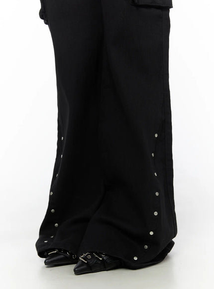 Studded Bootcut Pants CL503 Black close-up of hem showing silver stud embellishments along flared bootcut leg opening and black buckle shoes