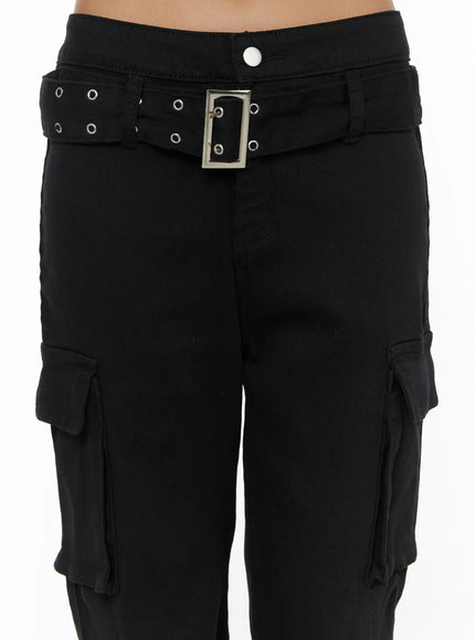 Studded Bootcut Pants CL503 Black detail close-up of waistband showing silver square buckle, double-row grommet belt, and white snap button