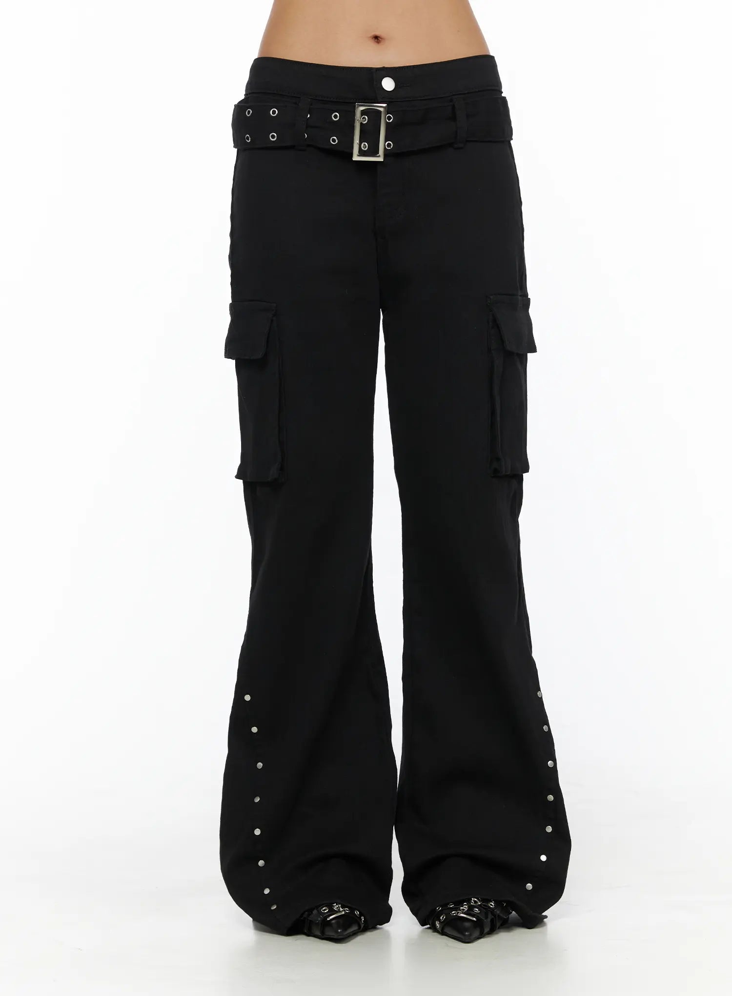 Studded Bootcut Pants CL503 Black front close-up on model showing low-rise waist, silver grommet belt with square buckle, and dual cargo pockets