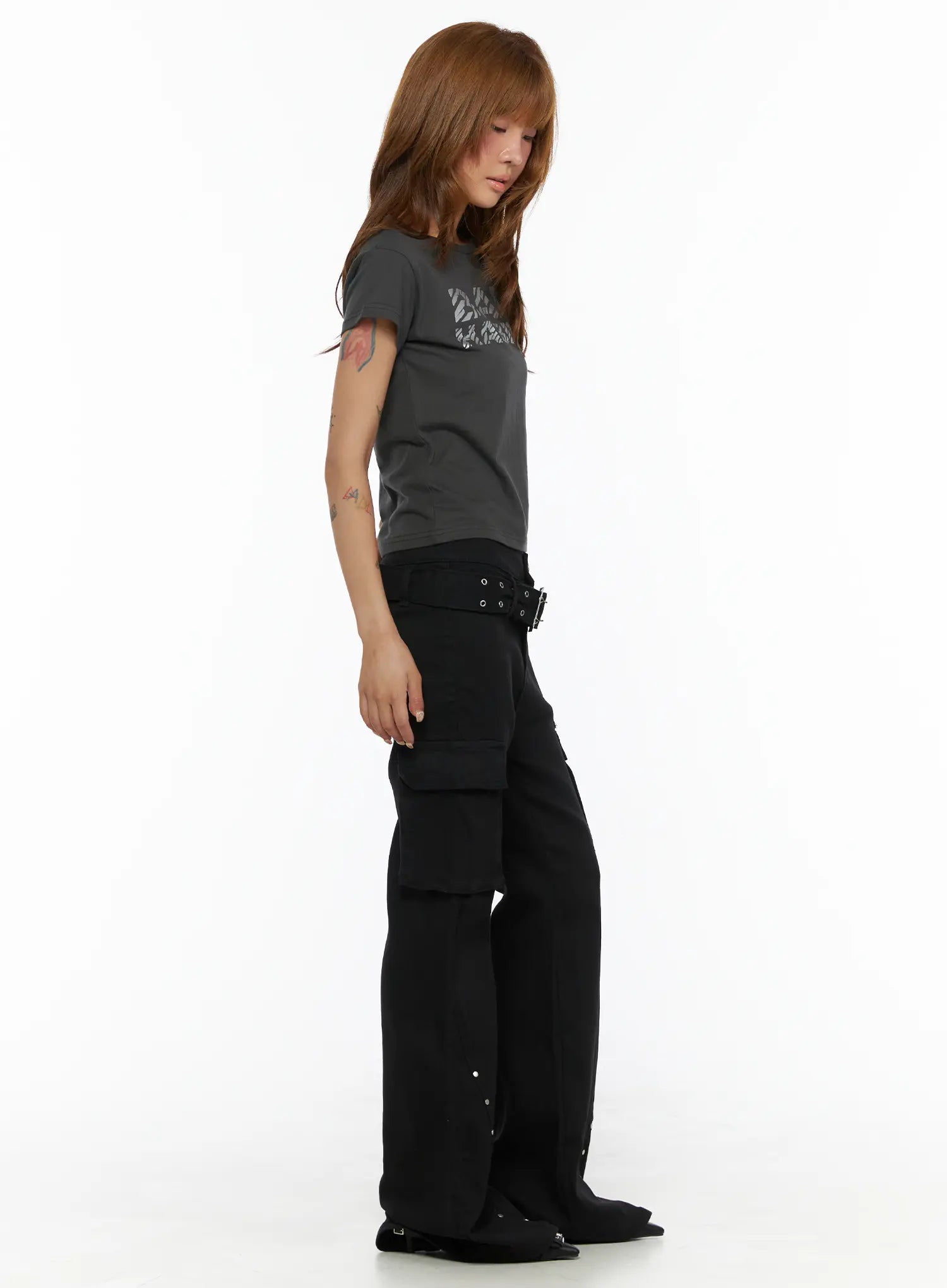 Studded Bootcut Pants CL503 Black full-length side view on model looking down, showing cargo pocket volume and stud embellishment along hem