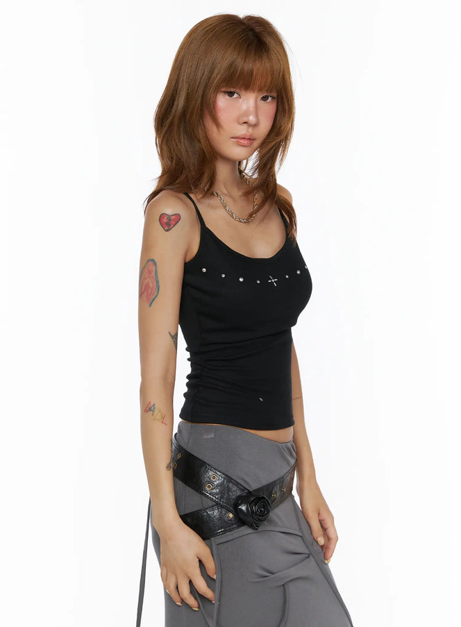 Studded Detail Tank Top CL503 Black angled front shot on model, silver cross and stud details along neckline, fitted ribbed cami styled with grey skirt