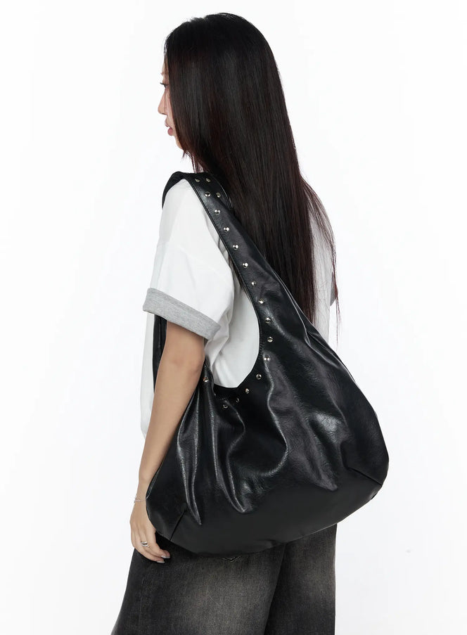 Studded Large Hobo Bag CL527 Black back view on model in white tee and dark jeans, oversized hobo silhouette with silver studded strap draped over shoulder