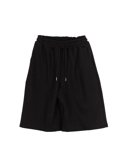 Studded Sweatshorts CU530 Black close-up detail of back patch pocket with silver ball-stud cross motif and row of round studs along pocket top edge