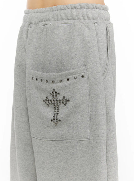 Studded Sweatshorts CU530 Gray close-up detail of front waistband drawstring elastic ruched waist and silver ball-stud cross motif on back patch pocket