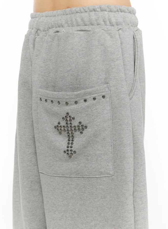 Studded Sweatshorts CU530 Gray close-up detail of front waistband drawstring elastic ruched waist and silver ball-stud cross motif on back patch pocket