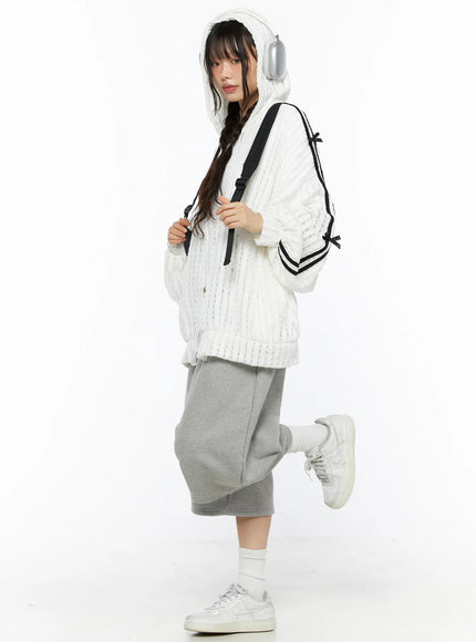 Studded Sweatshorts CU530 Gray side view on model wearing white hooded knit jacket and backpack leg raised showing wide-leg dropped-crotch silhouette
