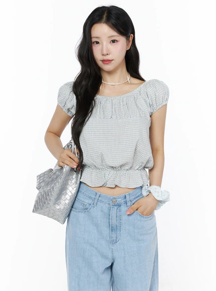 LEWKIN Summer Plaid Off-Shoulder Blouse IU525 Light blue front view on model styled with silver woven bag, pearl choker, and wide-leg jeans
