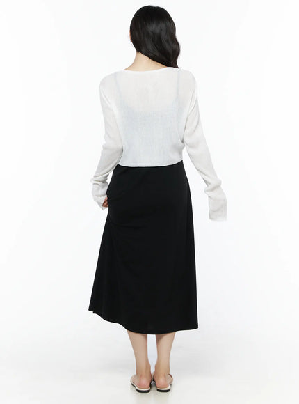 Summer Ribbed Crop Cardigan IU525 White back shot on model revealing sheer ribbed knit back panel and cropped hem above black A-line midi skirt