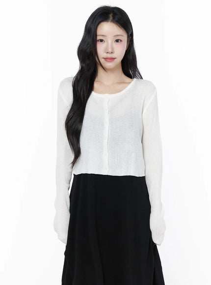 LEWKIN Summer Ribbed Crop Cardigan IU525 White S/M front shot on model wearing cropped sheer ribbed knit cardigan with button closure over black midi skirt
