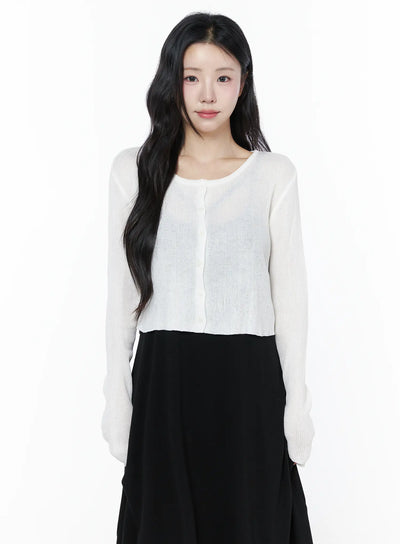 LEWKIN Summer Ribbed Crop Cardigan IU525 White S/M front shot on model wearing cropped sheer ribbed knit cardigan with button closure over black midi skirt