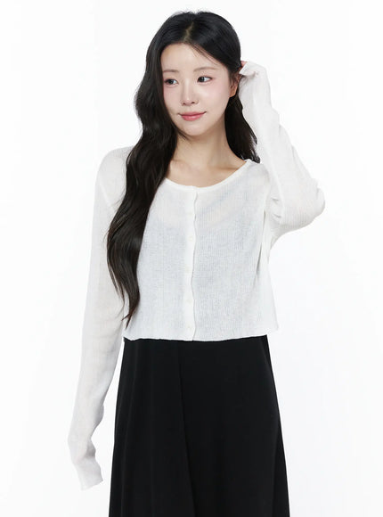 Summer Ribbed Crop Cardigan IU525 White front close-up on model with hand in hair showing round neckline button placket and lightweight sheer ribbed knit texture