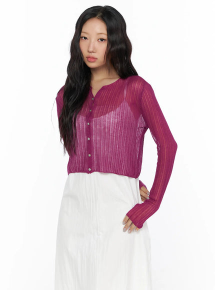 Summer Sheer Crop Cardigan CL510 Purple three-quarter front shot on model with hand on hip showing sheer ribbed knit, button front and thumbhole cuffs