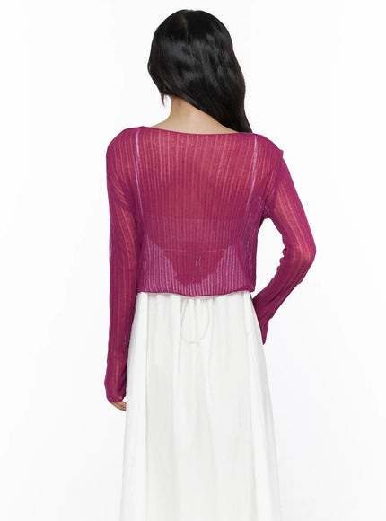 Summer Sheer Crop Cardigan CL510 Purple back shot on model showing sheer ribbed knit texture, open back neckline and cropped hem over white maxi dress