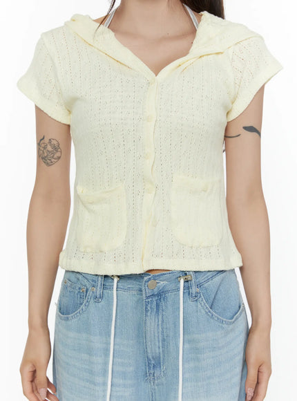 Summer Short Sleeve Hooded Knit Cardigan CL507 Yellow close-up front detail shot on model, pointelle openwork knit fabric with center button placket and two front patch pockets