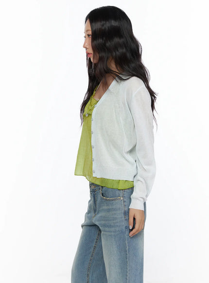 Summer V-Neck Cardigan CL510 Light gray side shot on model upper-body view sheer thin knit fabric V-neck button placket layered over yellow-green camisole