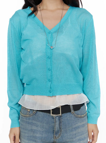 Summer V-Neck Cardigan CL510 Turquoise close-up front detail shot on model V-neck button placket sheer lightweight knit layered over white ruffled top with belt