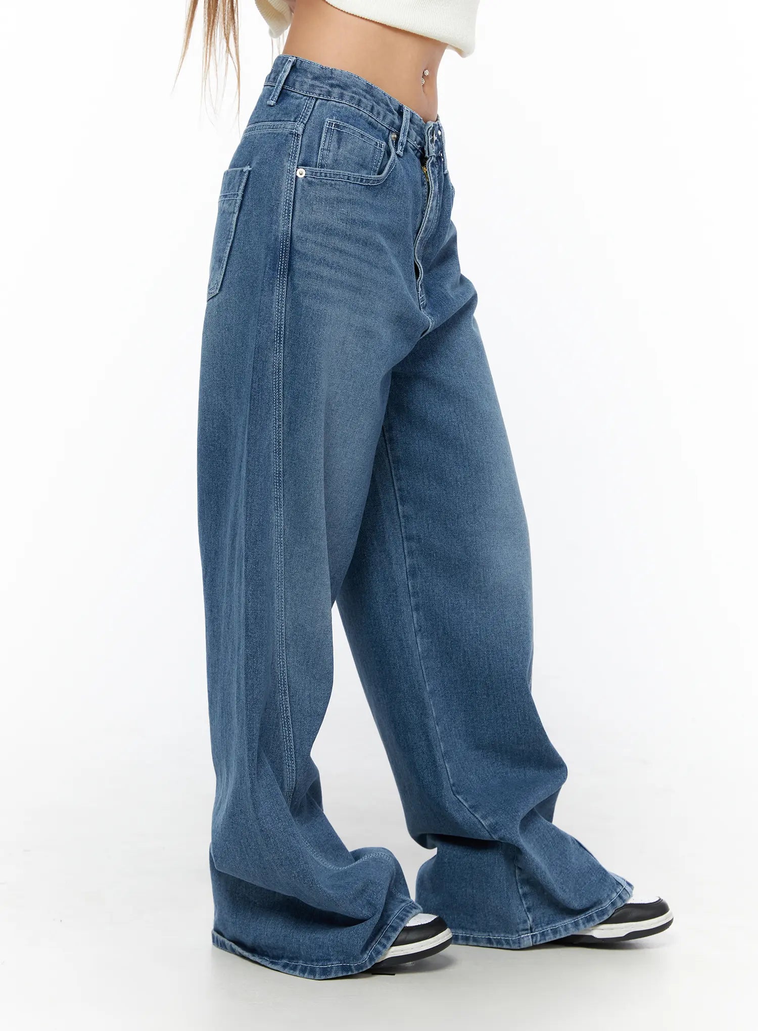 Suna Washed Wide Leg Jeans CU523 Blue side shot on model showing curved wide leg silhouette side pocket and washed denim texture