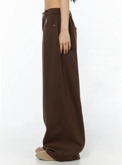 Tailored Wide Leg Sweatpants IL509 Brown true side profile shot on model from waist down, showing clean silhouette and extreme wide-leg volume pooling at mules