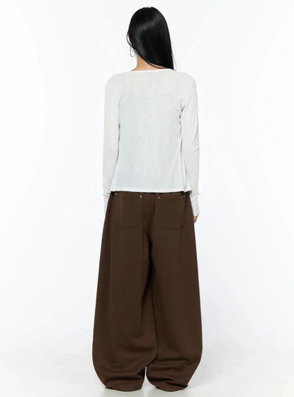 Tailored Wide Leg Sweatpants IL509 Brown back full-length shot on model wearing white cardigan, revealing back patch pockets and billowing wide-leg hem