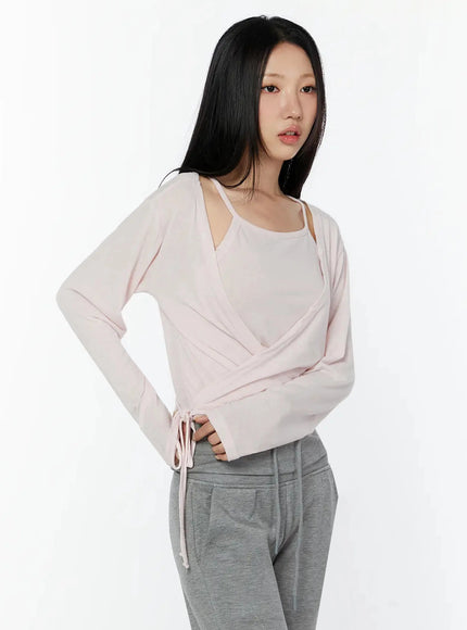 Tank And Layered Wrap Cardigan IU524 Pink three-quarter front shot model hand on hip showing wrap bodice drape and side tie with gray sweatpants