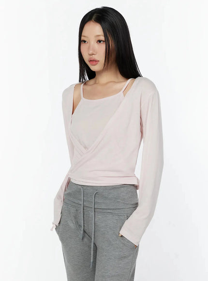 Tank And Layered Wrap Cardigan IU524 Pink upper-body front shot model showing wrap drape cami strap visible shoulder cutout and soft knit fabric texture