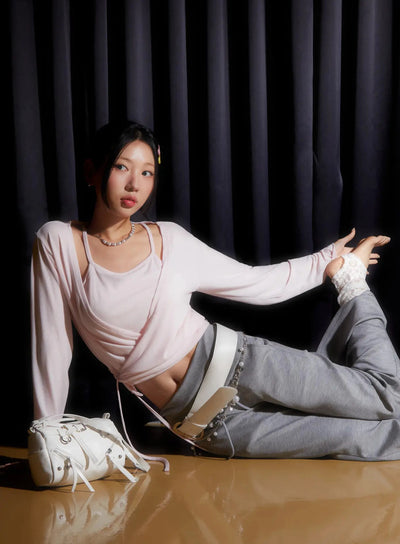 LEWKIN Tank And Layered Wrap Cardigan IU524 Pink editorial shot model seated on floor wearing wrap top over cami with gray wide-leg pants