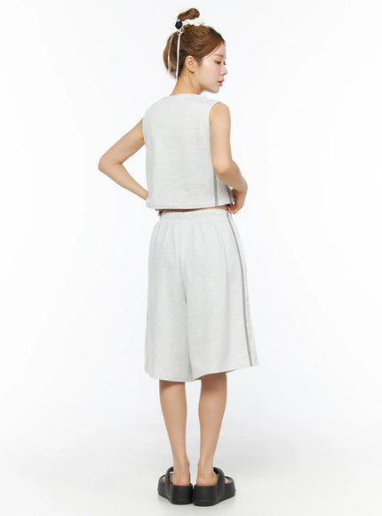 Tank Top and Track Shorts Set CL501 Light gray full-length back model shot, sleeveless crop top and wide-leg shorts with gray side stripes, hand on hip, black platform sandals
