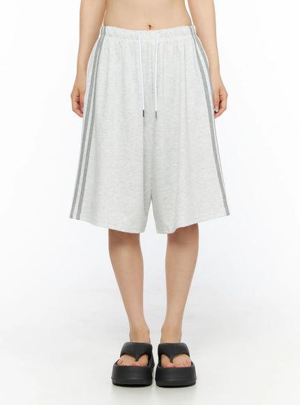 Tank Top and Track Shorts Set CL501 Light gray front close-up model shot of wide-leg shorts, elastic drawstring waistband with dual gray side stripes, black platform sandals